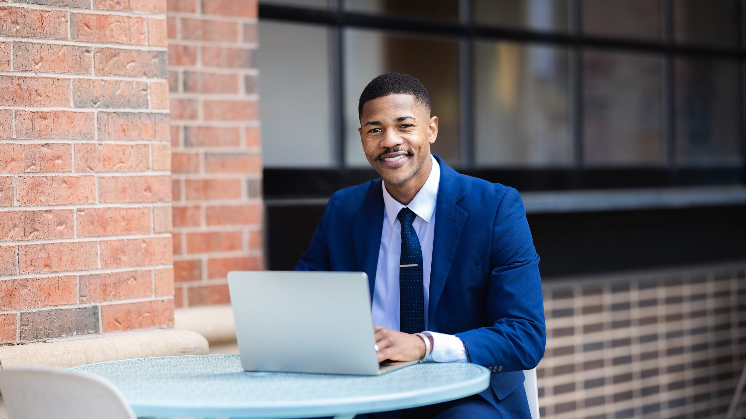 Man working on laptop outside.